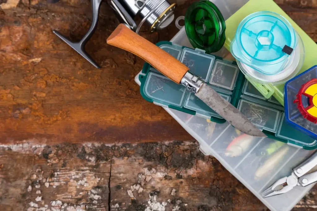 A close-up of essential fishing tools, including pliers, a sharp line cutter, and a well-stocked tackle box, ensuring a hassle-free fishing experience.